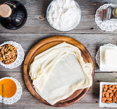 Ingredients for making homemade baklava,phyllo dough, nuts, hone