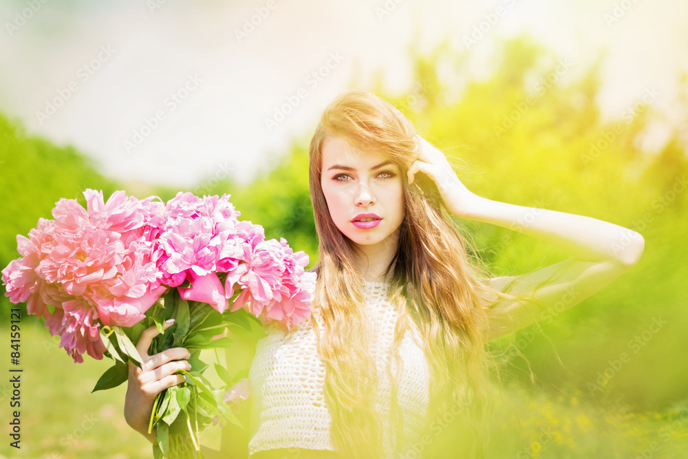 Fototapeta premium Gorgeous young woman with peonies bouquet