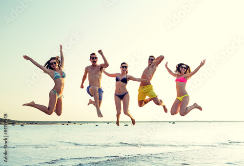 smiling friends in sunglasses on summer beach © Syda Productions