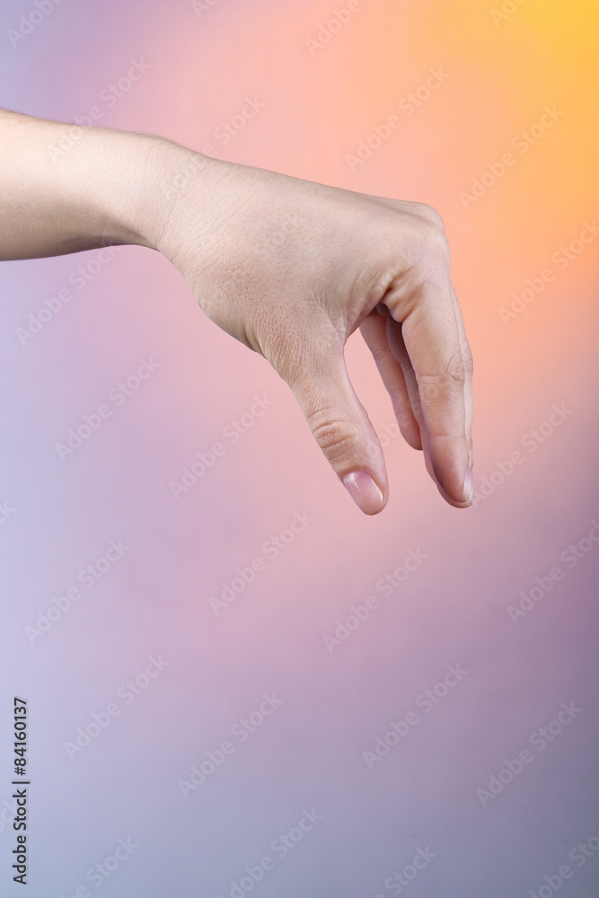 Female hand on colorful background Female hand on colorful background