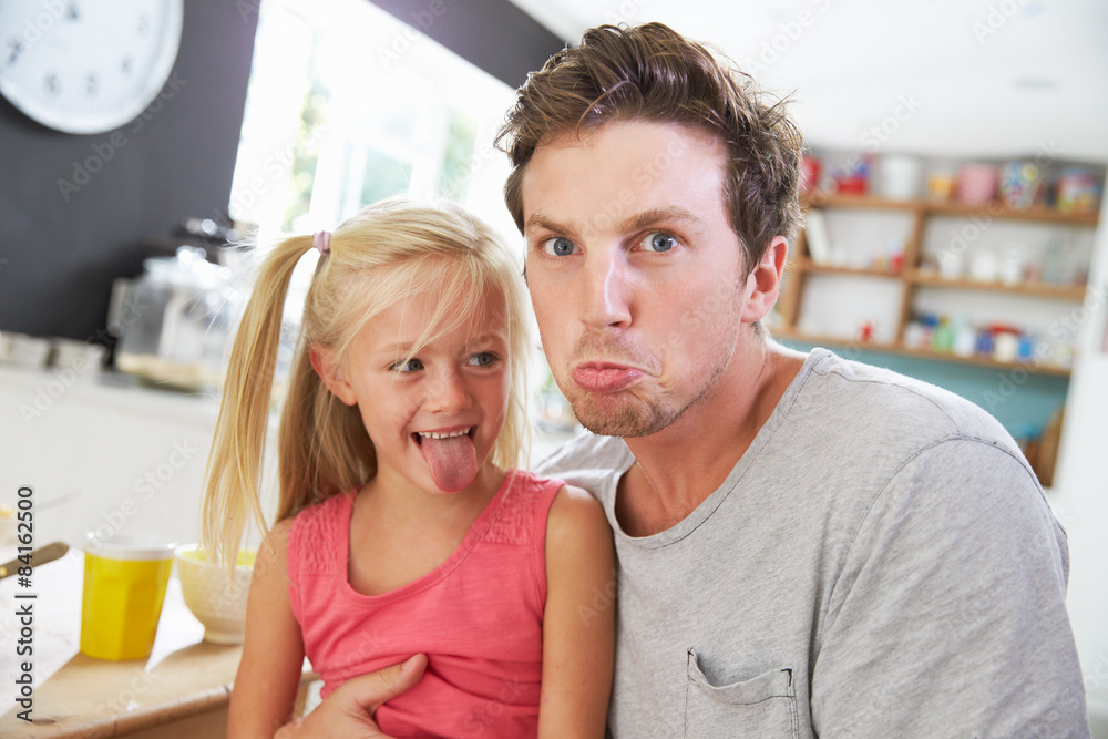 Father And Daughter Making Funny Faces At Breakfast Table Father And Daughter Making Funny Faces At Breakfast Table
