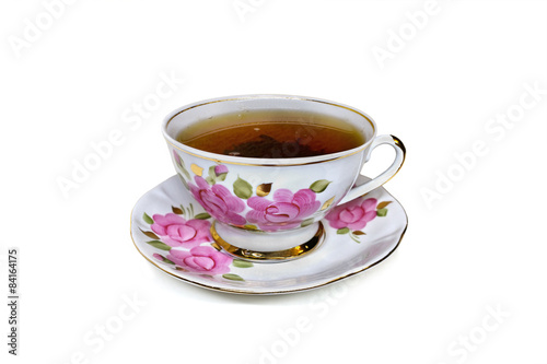 cup with roses on a white background closeup