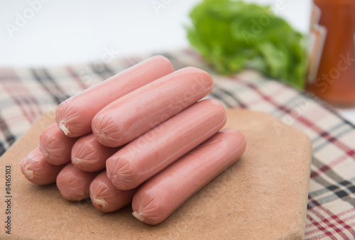 hot dog sausages on wood pad