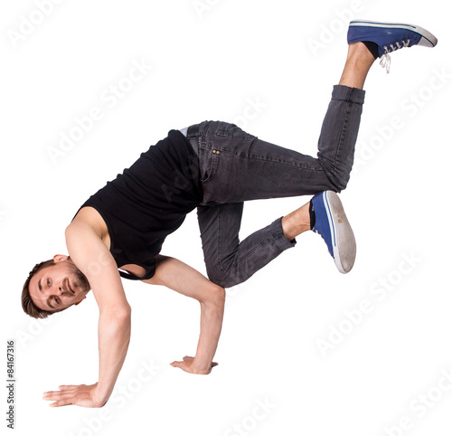 Break dancer doing handstand against white background