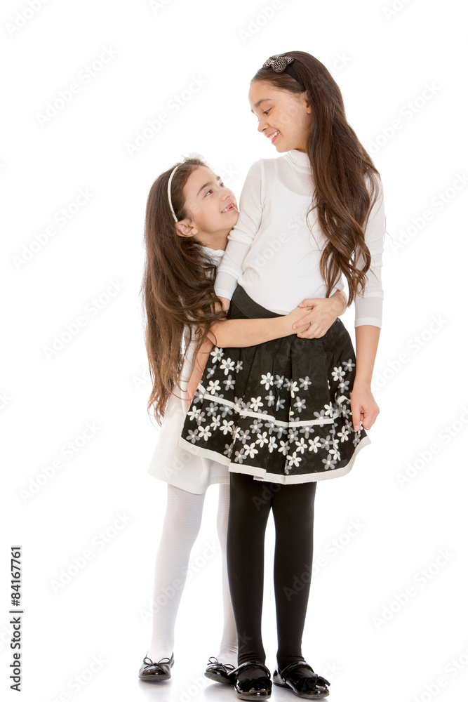 Younger and older sister hugging Younger and older sister hugging