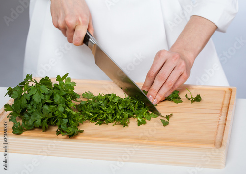 Cook chopping fresh parsley