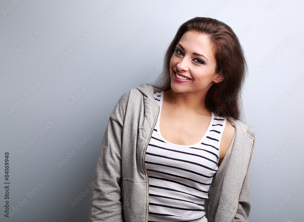 Fototapeta premium Happy young casual woman with smile on blue background