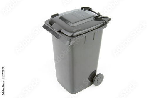 Grey garbage wheelie bin with a closed lid on a white background. photo