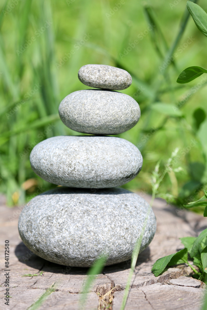 Stack of spa stones over green grass background Stack of spa stones over green grass background