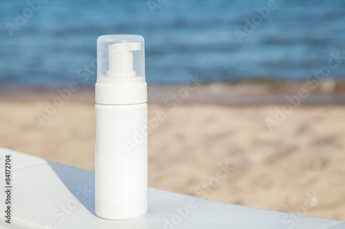 Spray sunscreen on the sea beach