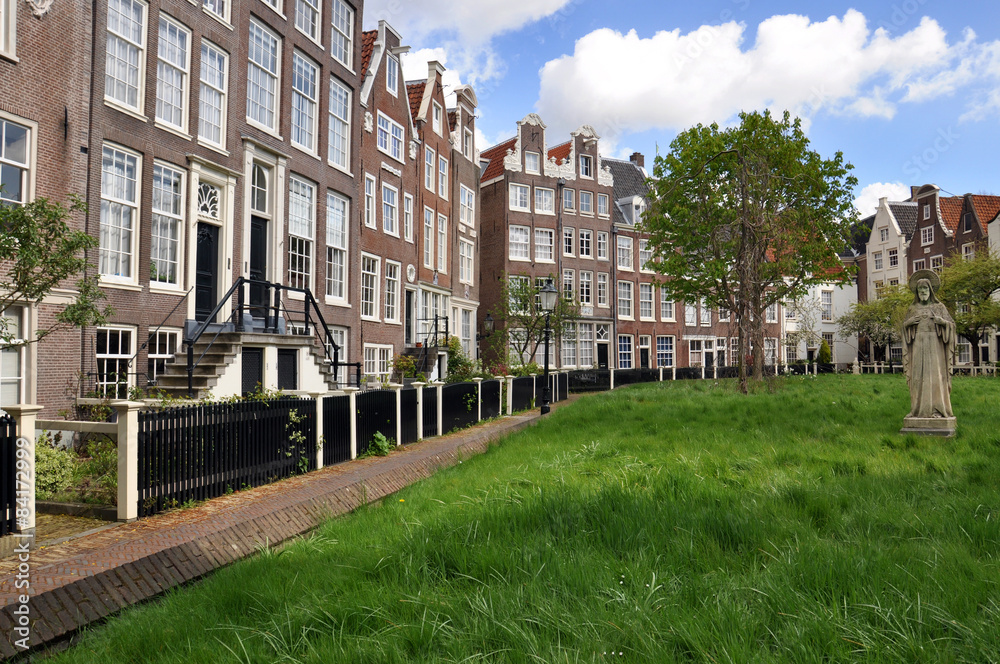 An old traditional oblique houses at the Begijnhof in Amsterdam