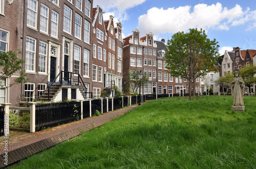 An old traditional oblique houses at the Begijnhof in Amsterdam © Savvapanf Photo ©