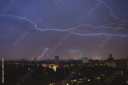 lightning strikes over night town during a thunderstorm. Kiev, U