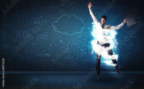 Happy business man jumping with storm cloud around him