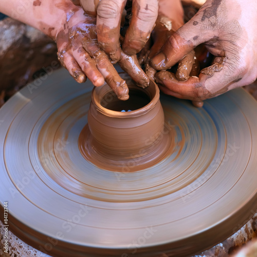 Hands working on pottery wheel