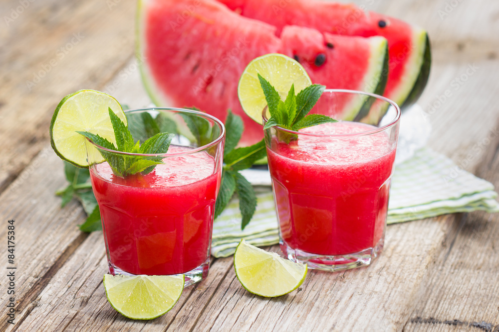 Two glasses with watermelon smoothies with lime and mint Two glasses with watermelon smoothies with lime and mint