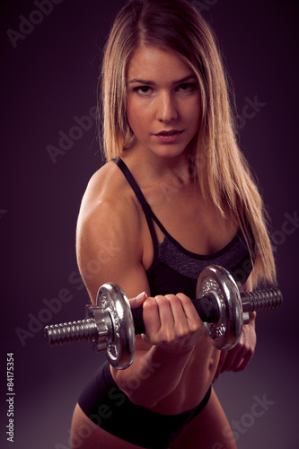 attractive young woman working out with dumbbells - bikini fitne