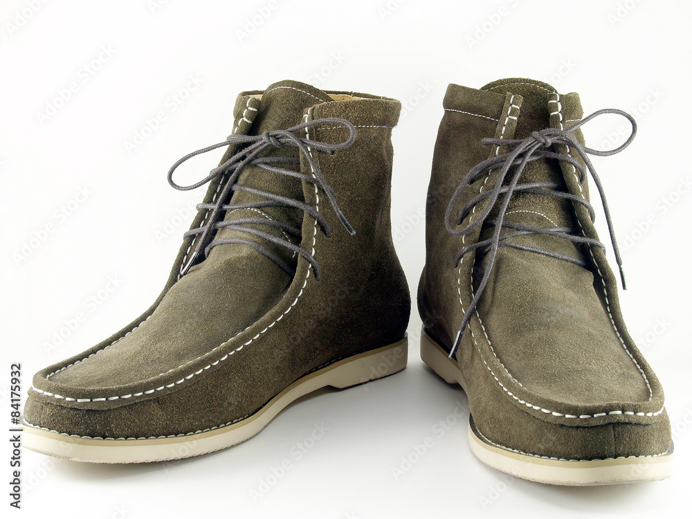 close-up olive green suede shoes isolated on white background, pair of casual velvet leather boots shoe with rubber sole for hiking