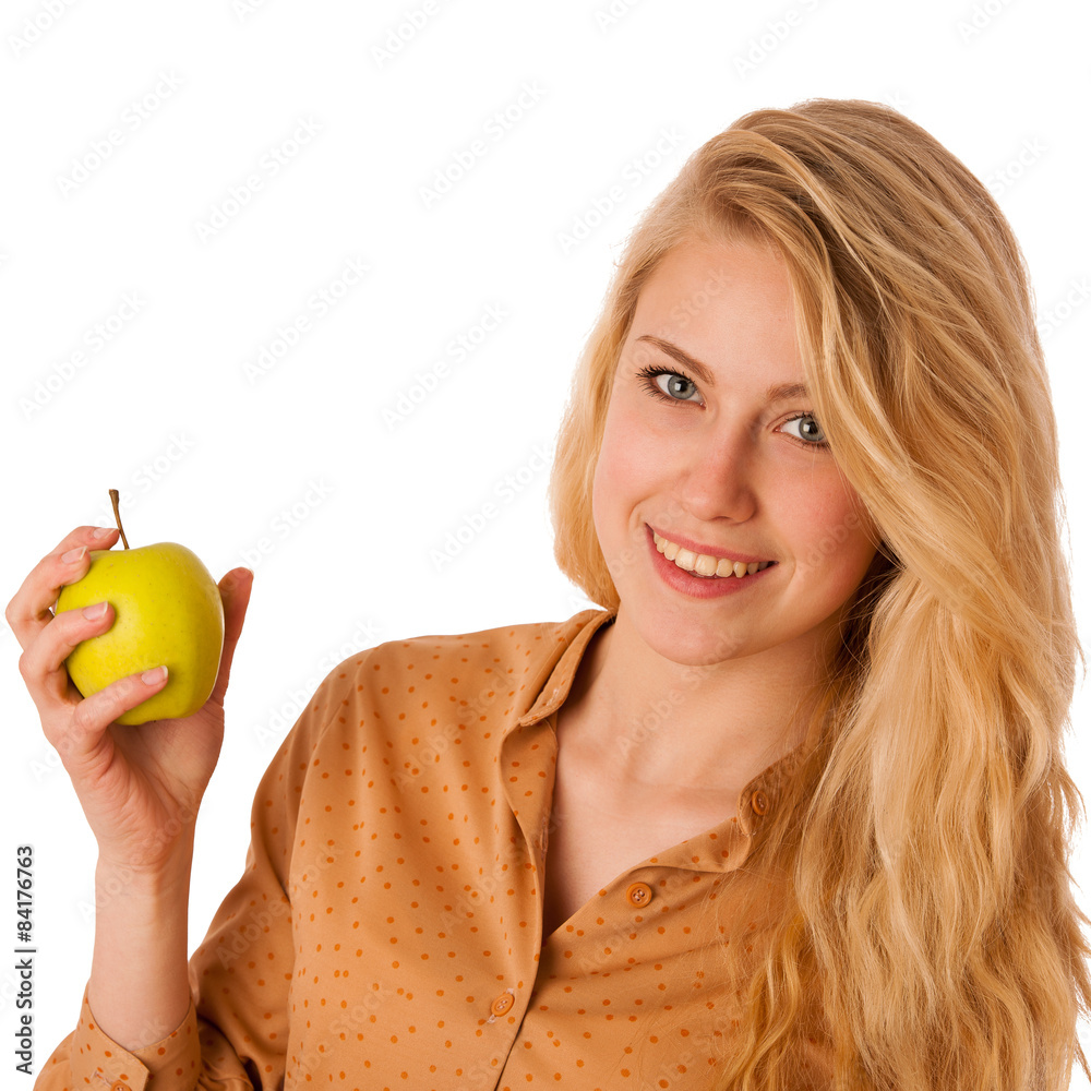 Beautiful young caucasian blonde woman eats a green apple as a s Beautiful young caucasian blonde woman eats a green apple as a s