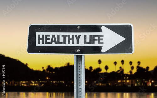 Healthy Life direction sign with sunset background