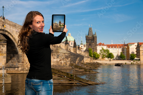 Photography Beautiful young tourist woman photographing sites in Prague Czec