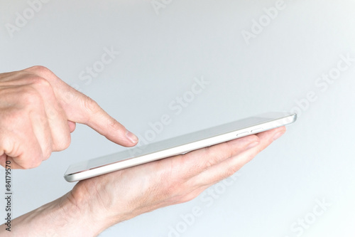 Male hand holding modern tablet or large smart phone