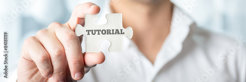 Businessman Shows Puzzle Piece with Tutorial Text