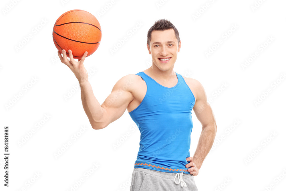 Handsome young man posing with a basketball in his hand Handsome young man posing with a basketball in his hand