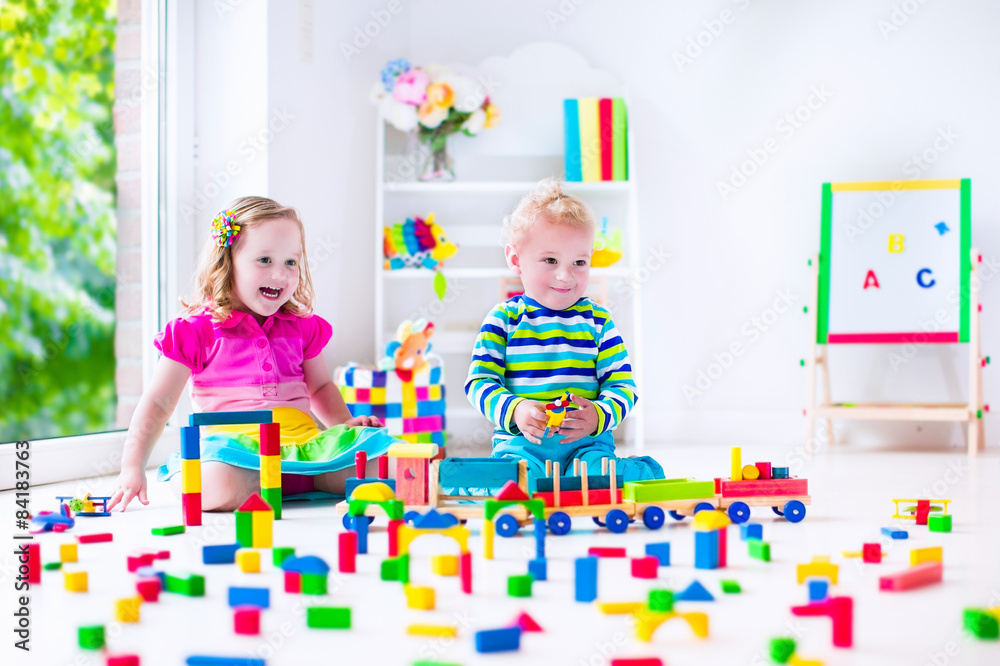 Fototapeta premium Kids playing at day care with wooden toys