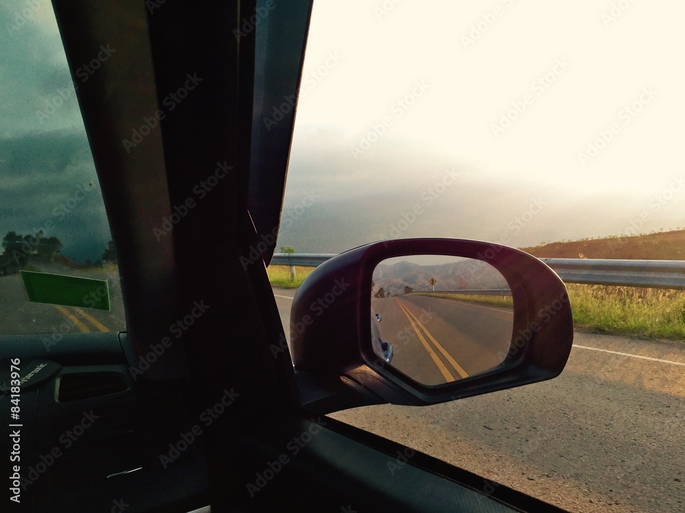 reflection from car mirror while driving on road reflection from car mirror while driving on road