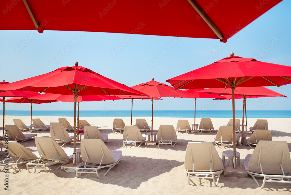 Beach chairs and umbrellas on a sand beach