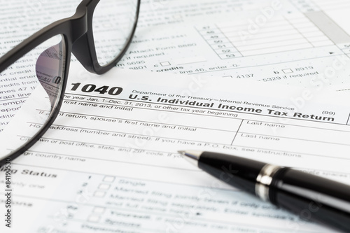 Tax form with glasses  and pen