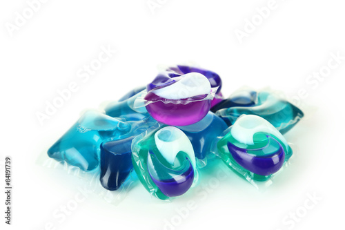 Gel capsules with laundry detergent on a white background