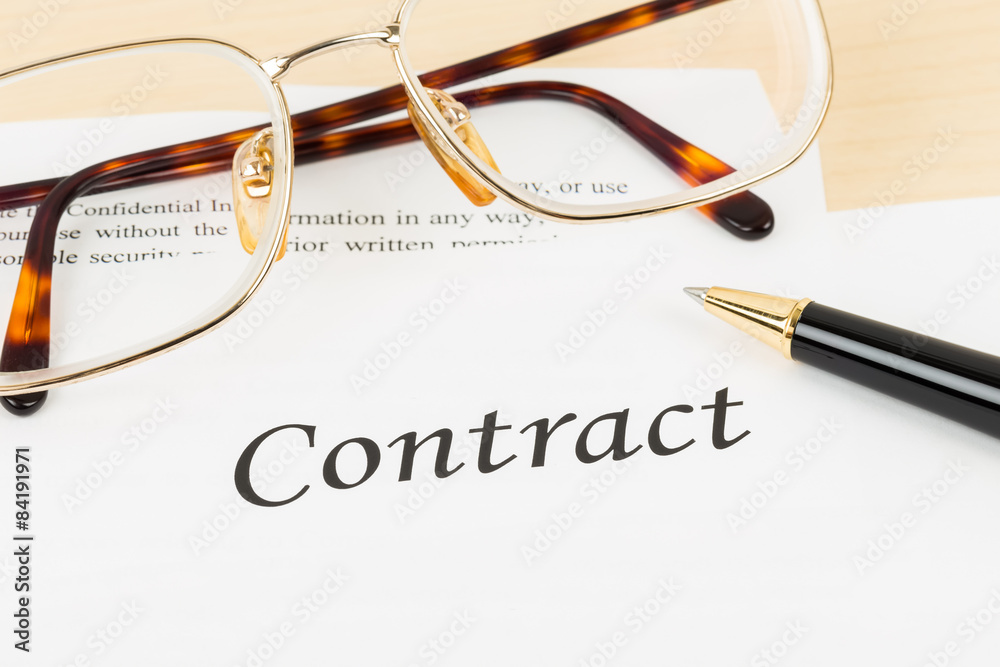 Business contract with pen and glasses; contract and information Business contract with pen and glasses; contract and information