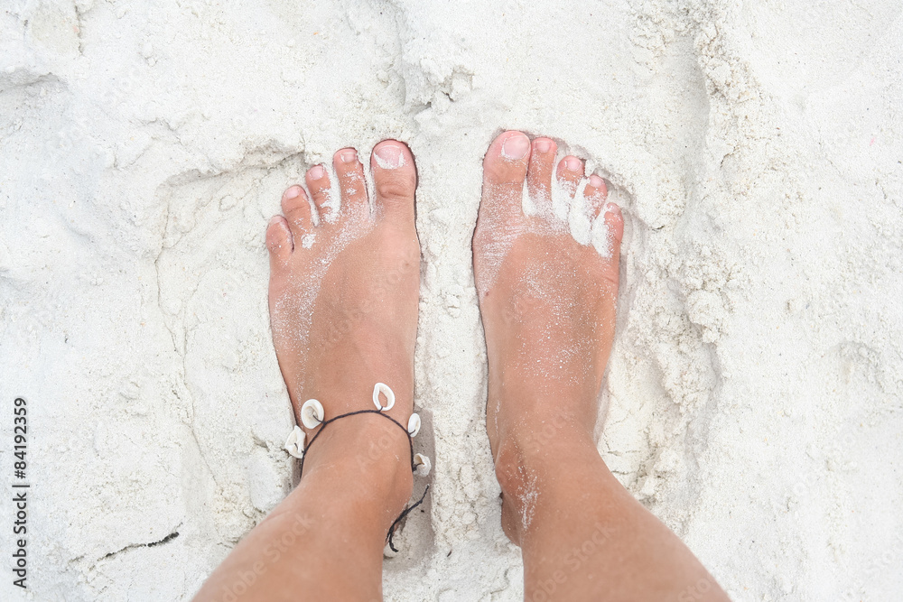 Fototapeta premium Feet on the white sand.