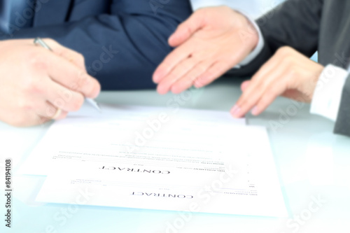 Business people signing a contract