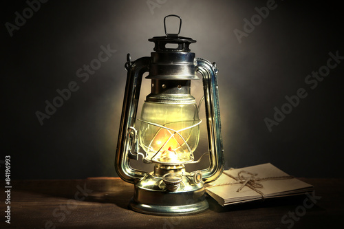 Kerosene lamp and letters on dark grey background