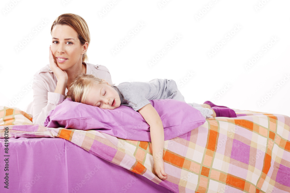 Cute little girl with her mother lying on a bed, Cute little girl with her mother lying on a bed,