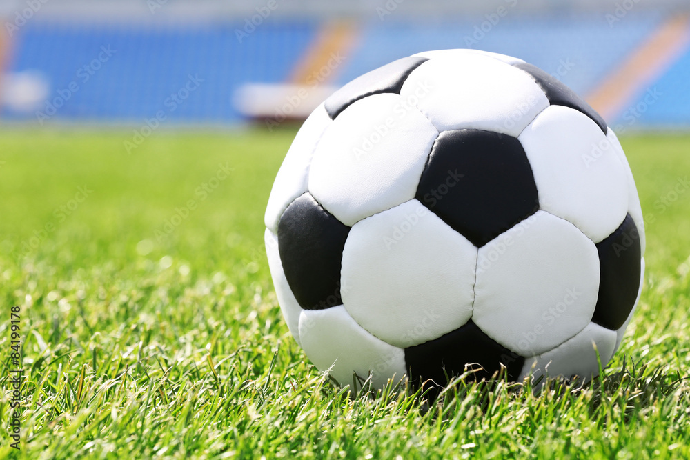 Fototapeta premium Soccer ball on green field