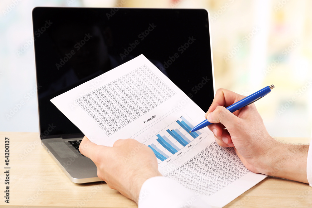 Businessman analyzing charts, closeup Businessman analyzing charts, closeup