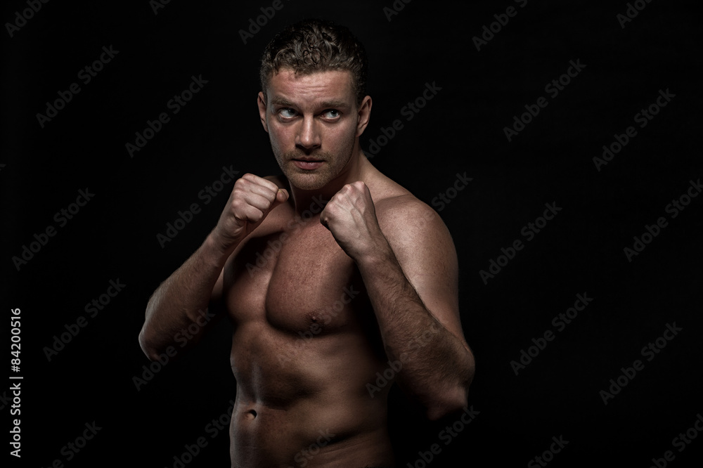 Fototapeta premium strong handsom man on black background