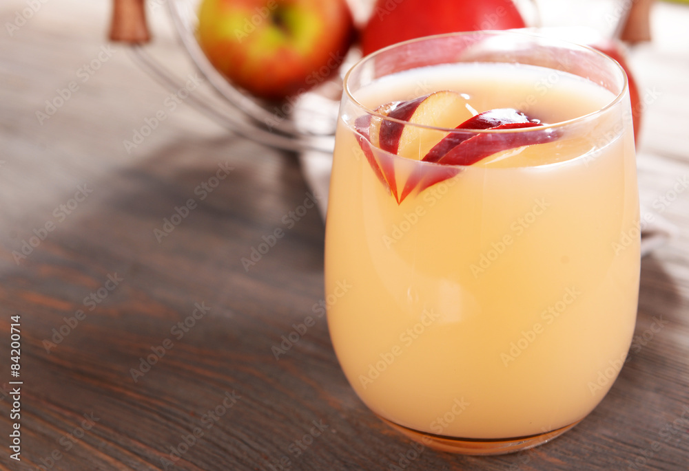 Glass of apple cider with fruits on wooden background Glass of apple cider with fruits on wooden background