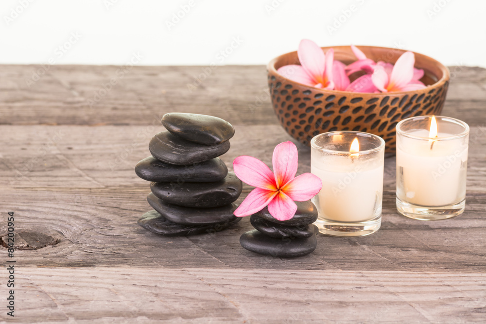 Plumeria flowers and black stones close up Plumeria flowers and black stones close up
