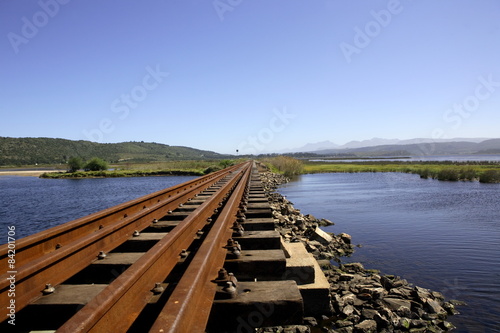 Fototapeta Naklejka Na Ścianę i Meble -  Railway bridge over Swartvlei Lake, Western Cape, South Africa