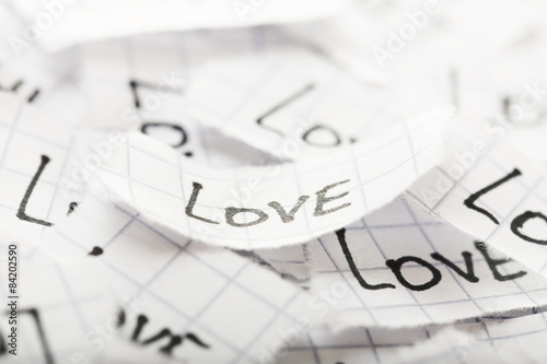 Words LOVE written on torn paper, closeup © Africa Studio