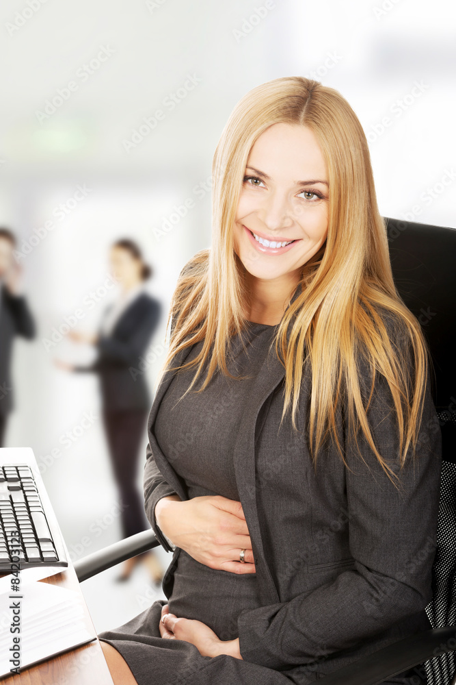 Pregnant woman sitting in the office Pregnant woman sitting in the office