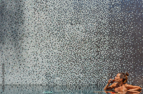 GIrl in pool with cola drink