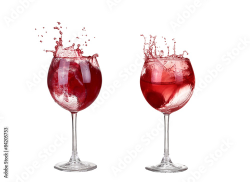 red wine pouring into wine glass isolated on a white background
