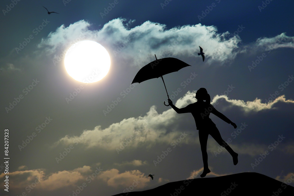 Silhouette of umbrella woman jump and sunset with big sun, landscape Silhouette of umbrella woman jump and sunset with big sun, landscape