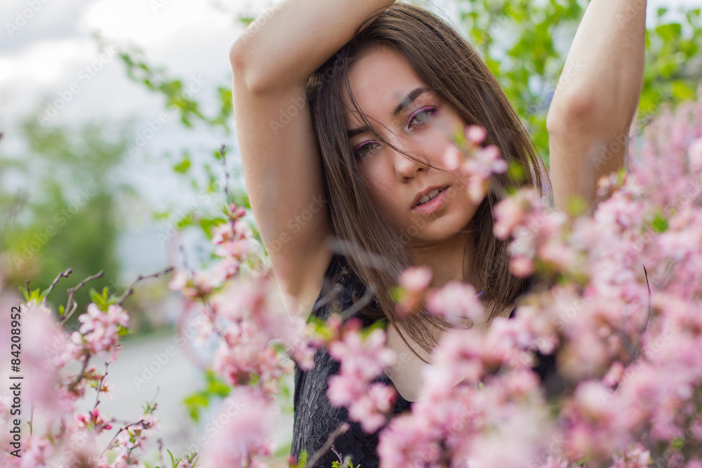 portrait of young beautiful girl in flowers